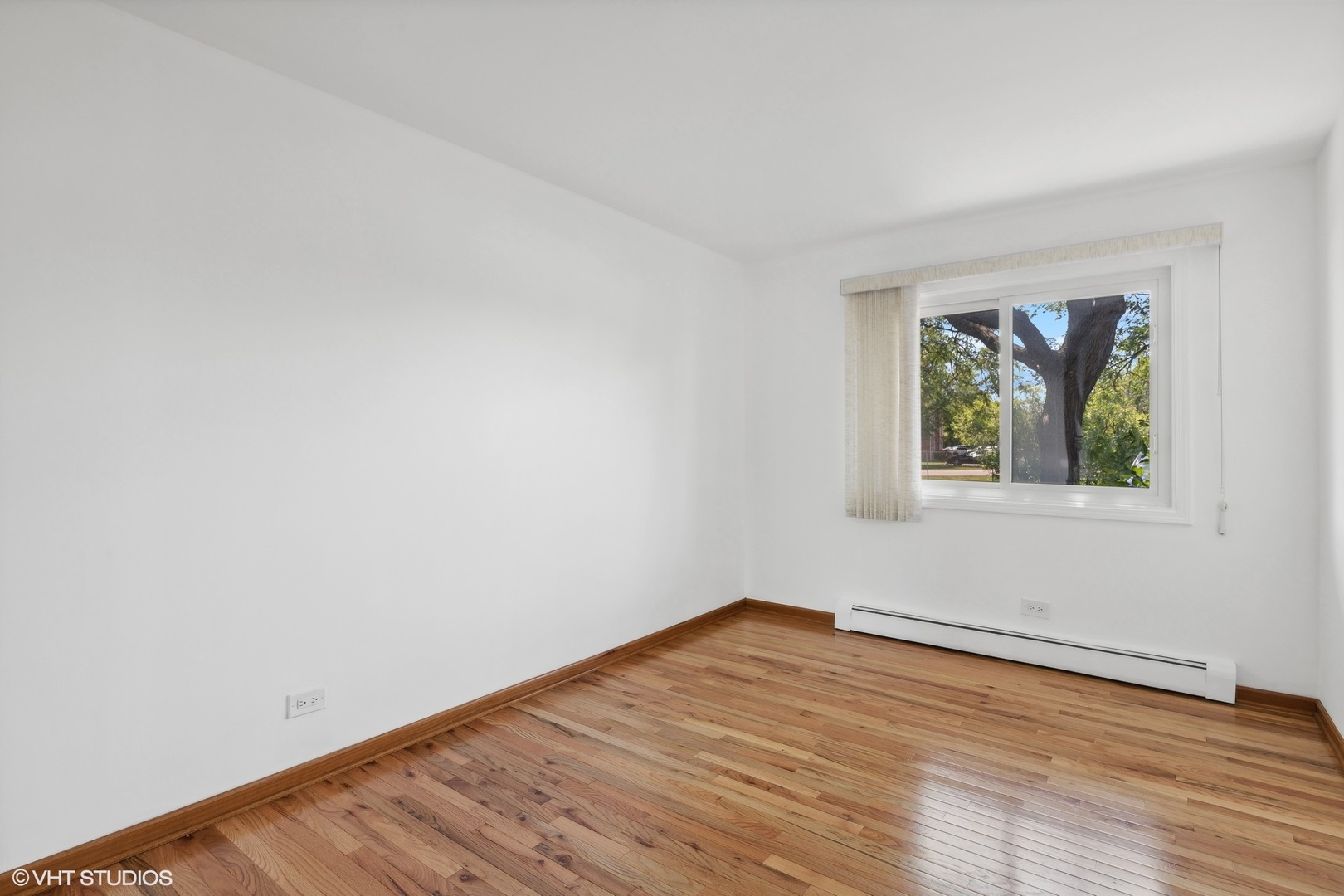 10357 Dearlove Road, Unit 1I Glenview, IL 60025 - Photo 10 of 16 wooden floor in an empty room with a window
