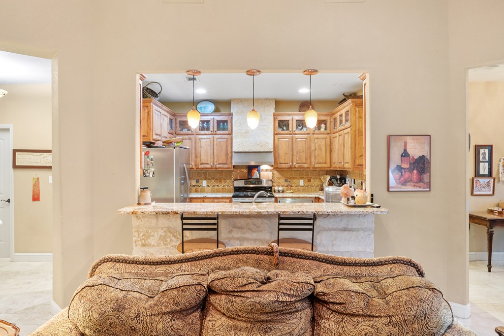 2142 Lightstone Fredericksburg, TX 78624 - Photo 5 of 30 a living room with granite countertop furniture and painting on the wall