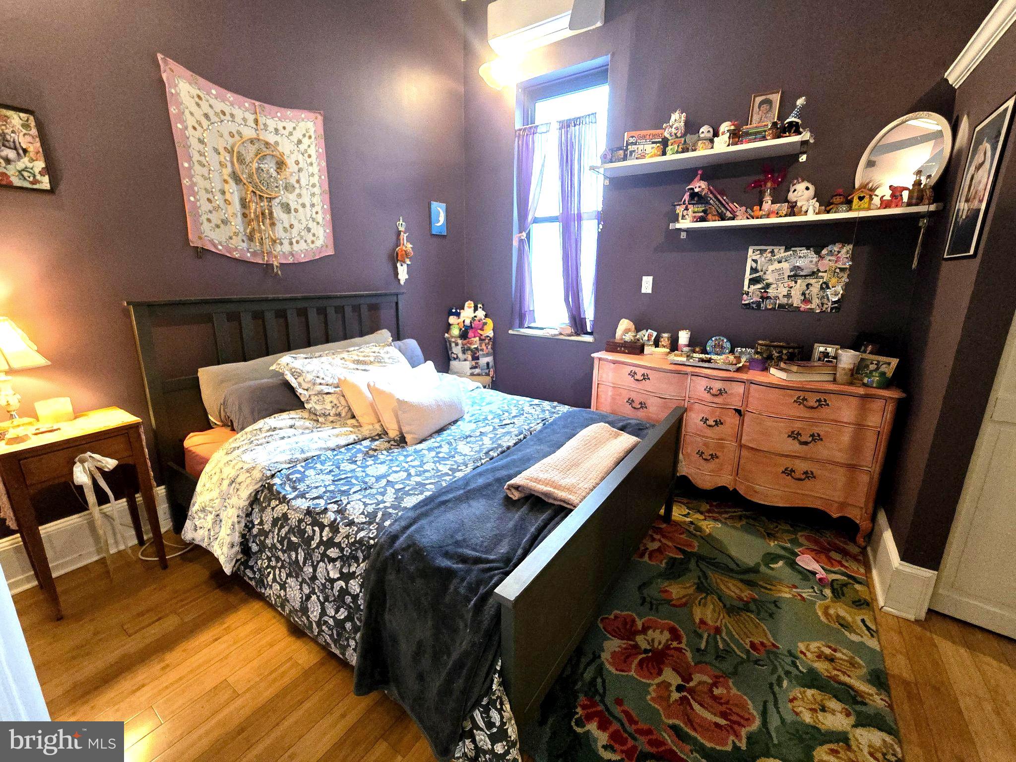 1320 South Broad Street, Unit A Philadelphia, PA 19146 - Photo 15 of 19 a bed sitting in a bedroom next to a lamp