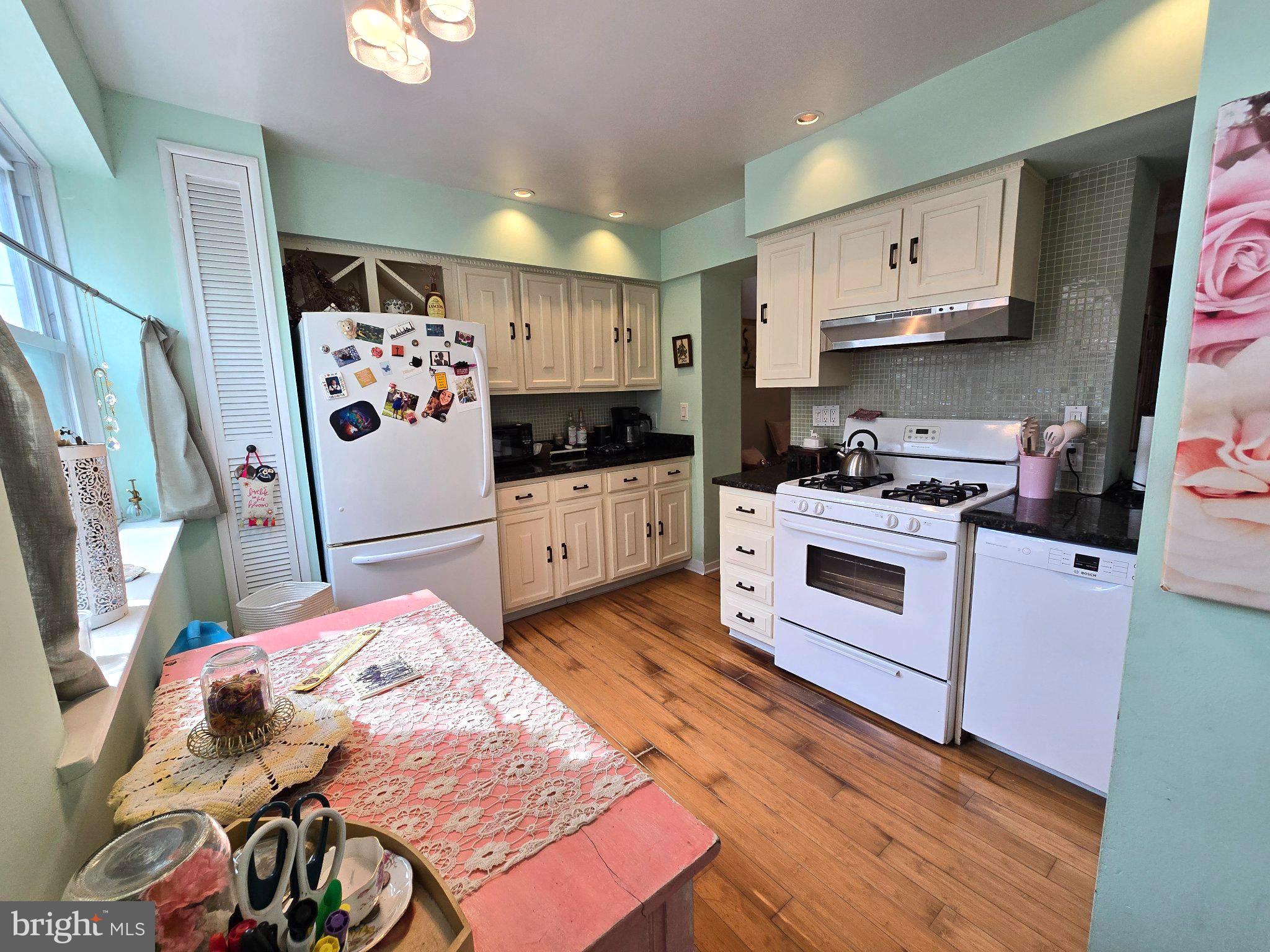 1320 South Broad Street, Unit A Philadelphia, PA 19146 - Photo 5 of 19 a kitchen with stainless steel appliances kitchen island granite countertop a stove a sink and a refrigerator