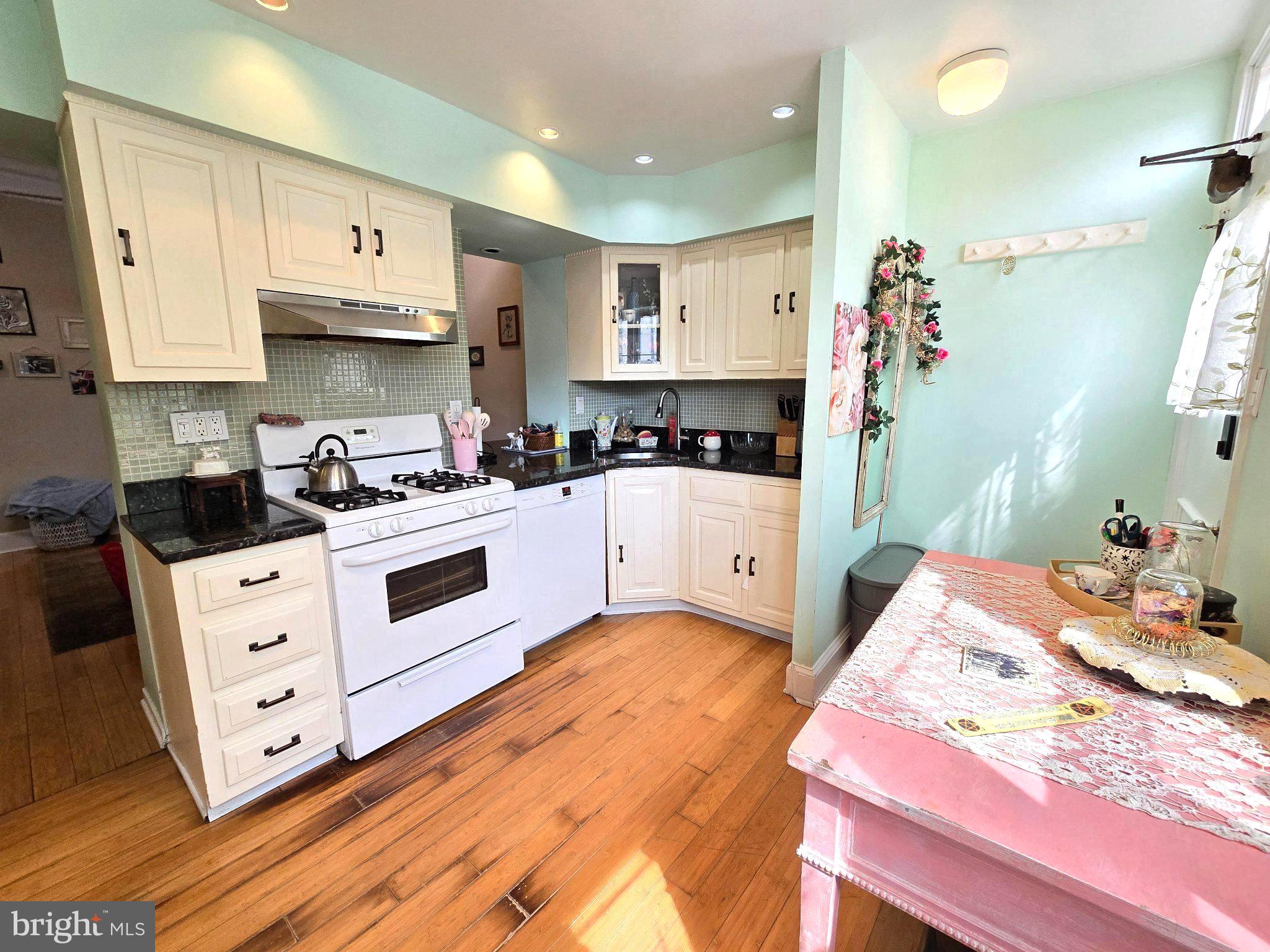 1320 South Broad Street, Unit A Philadelphia, PA 19146 - Photo 6 of 19 a kitchen with stainless steel appliances a stove a sink and white cabinets
