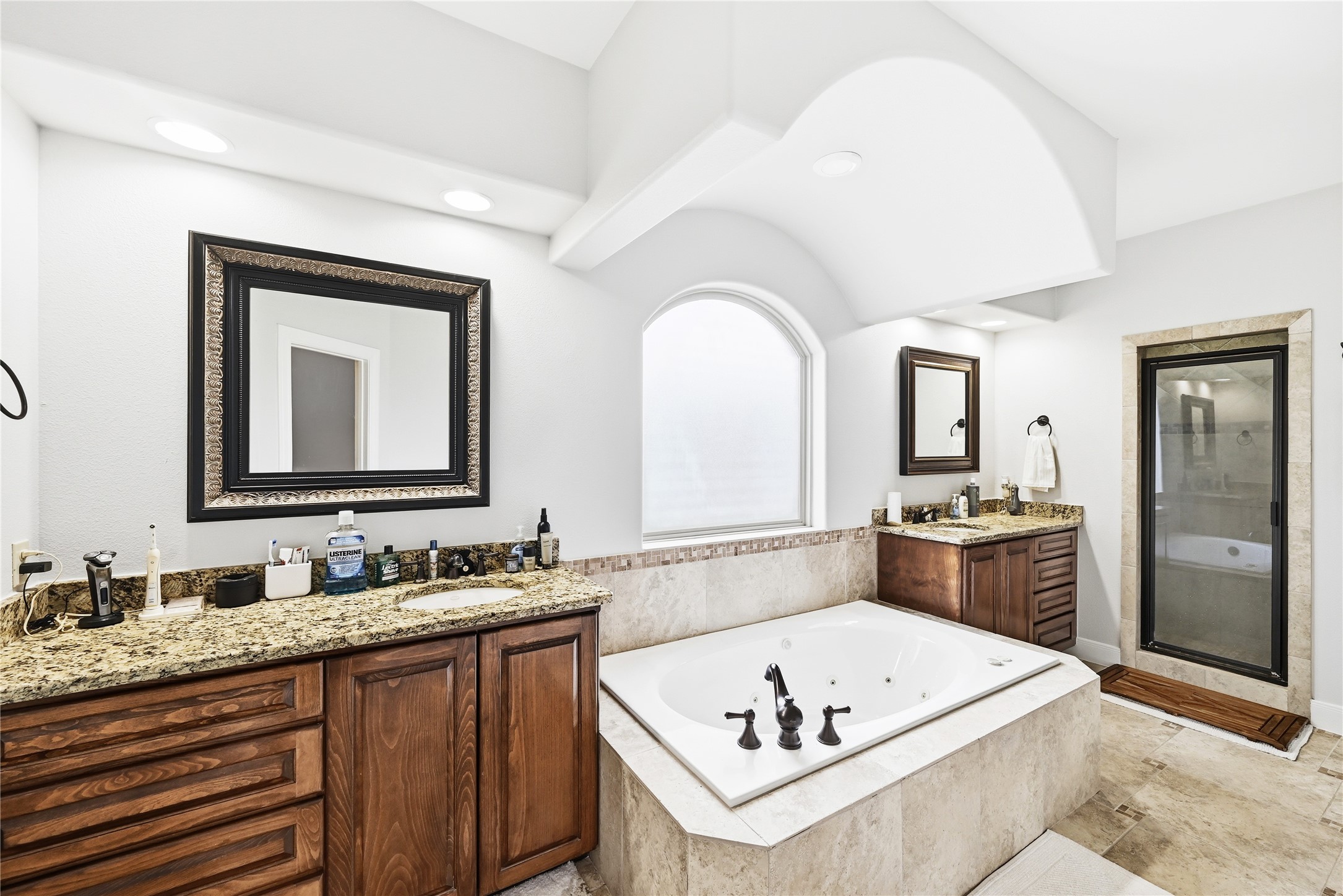 140 Winchester Road Bastrop, TX 78602 - Photo 20 of 35 Bathroom featuring two vanities, a shower stall, a tub with jets, and recessed lighting