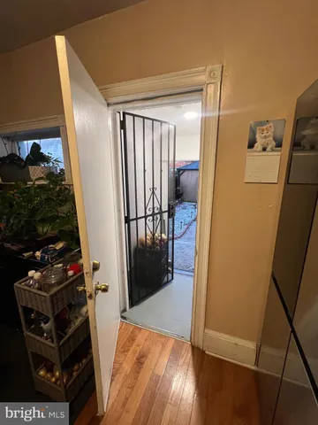 a view of a hallway with wooden floor and entryway