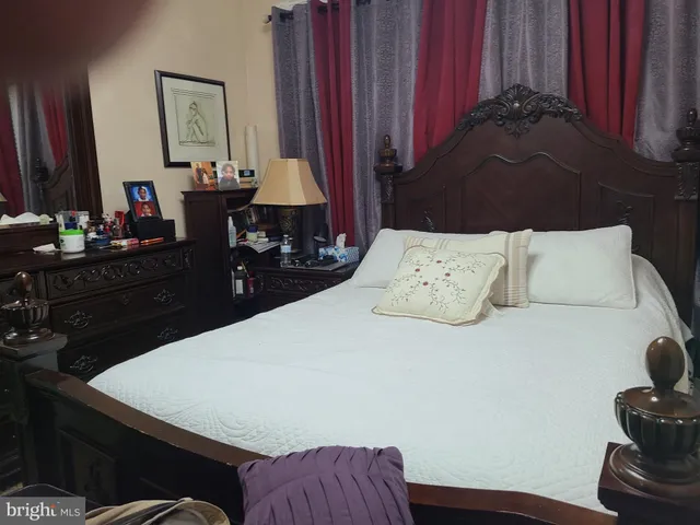 a bedroom with a bed and a dresser