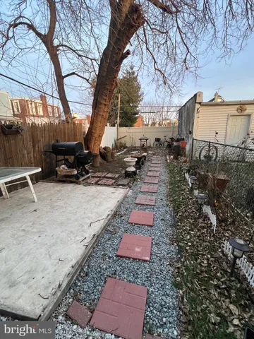 a backyard of a house with yard and outdoor seating