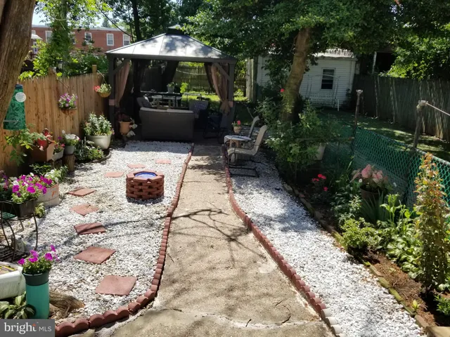 a view of a backyard with sitting area