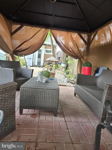 a outdoor space with the couches and dining table with the garden view