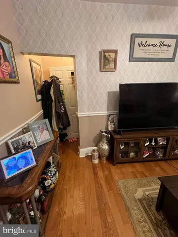 a room with wooden floor and gym equipment