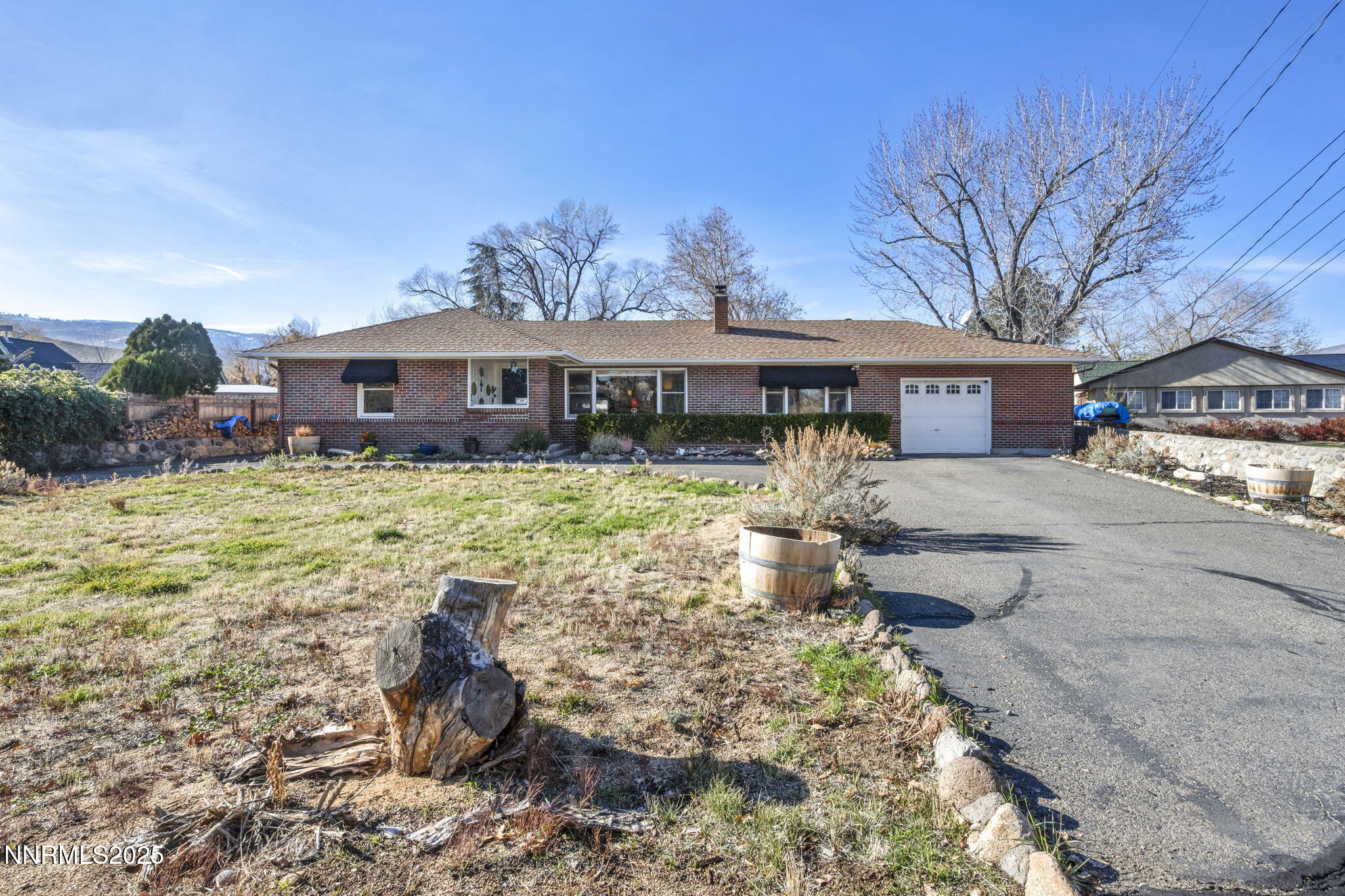 72 Suda Way Reno, NV 89509 - Photo 1 of 41 a front view of a house with a yard table and chairs