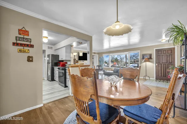 a view of a dining room with furniture and wooden floor