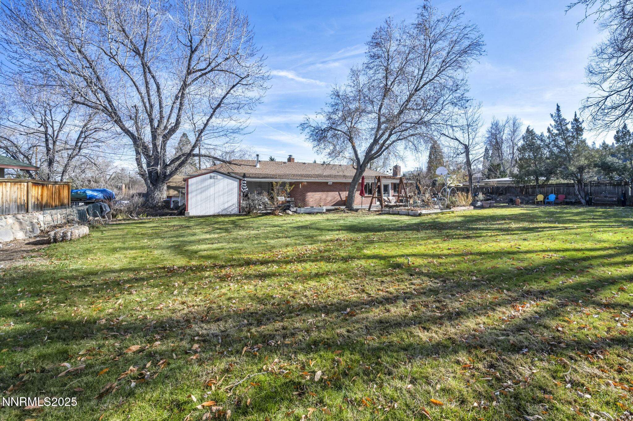 72 Suda Way Reno, NV 89509 - Photo 30 of 41 a view of a building with a big yard and large trees