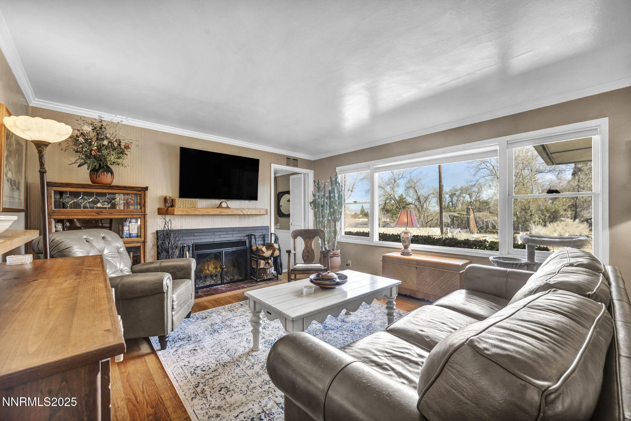 72 Suda Way Reno, NV 89509 - Photo 7 of 41 a living room with furniture a fireplace and a flat screen tv