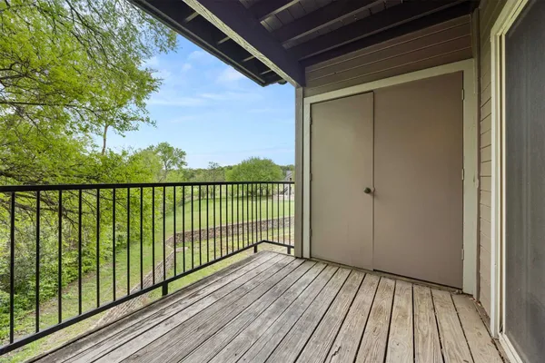 a view of a balcony with wooden floor