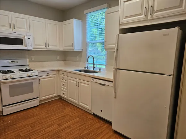 a kitchen with stainless steel appliances a refrigerator sink and cabinets