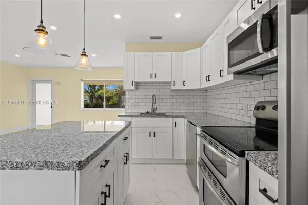 a kitchen with a sink stove and cabinets