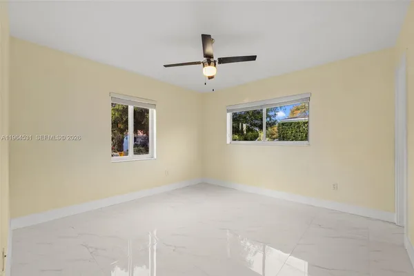 a bedroom with bed and a window