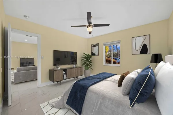 an empty room with windows and ceiling fan