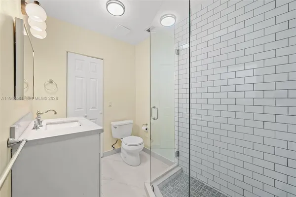 a bathroom with a shower sink and mirror