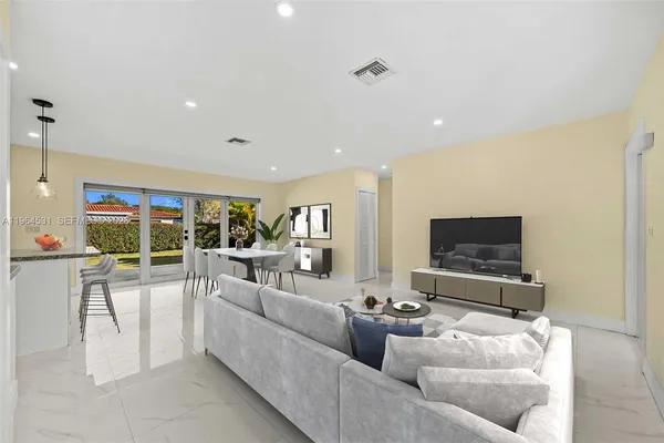 a living room with furniture and a flat screen tv