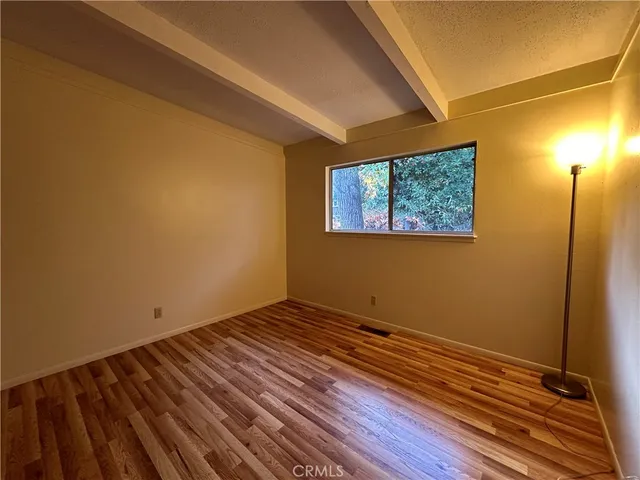 a view of room with wooden floor and window