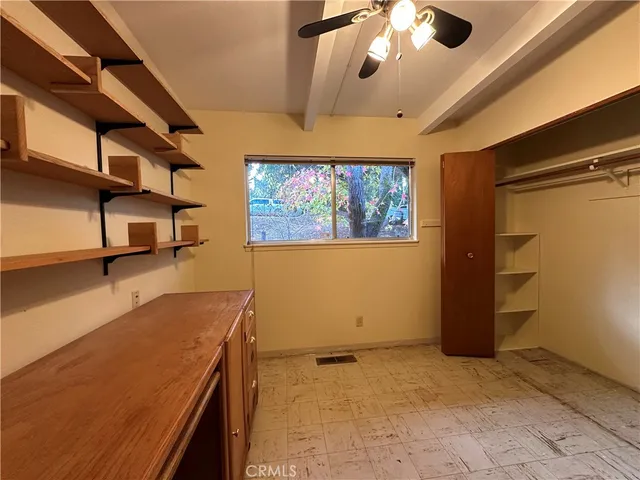 a view of a room with window and ceiling fan