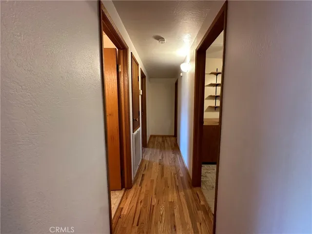 a view of hallway with wooden floor