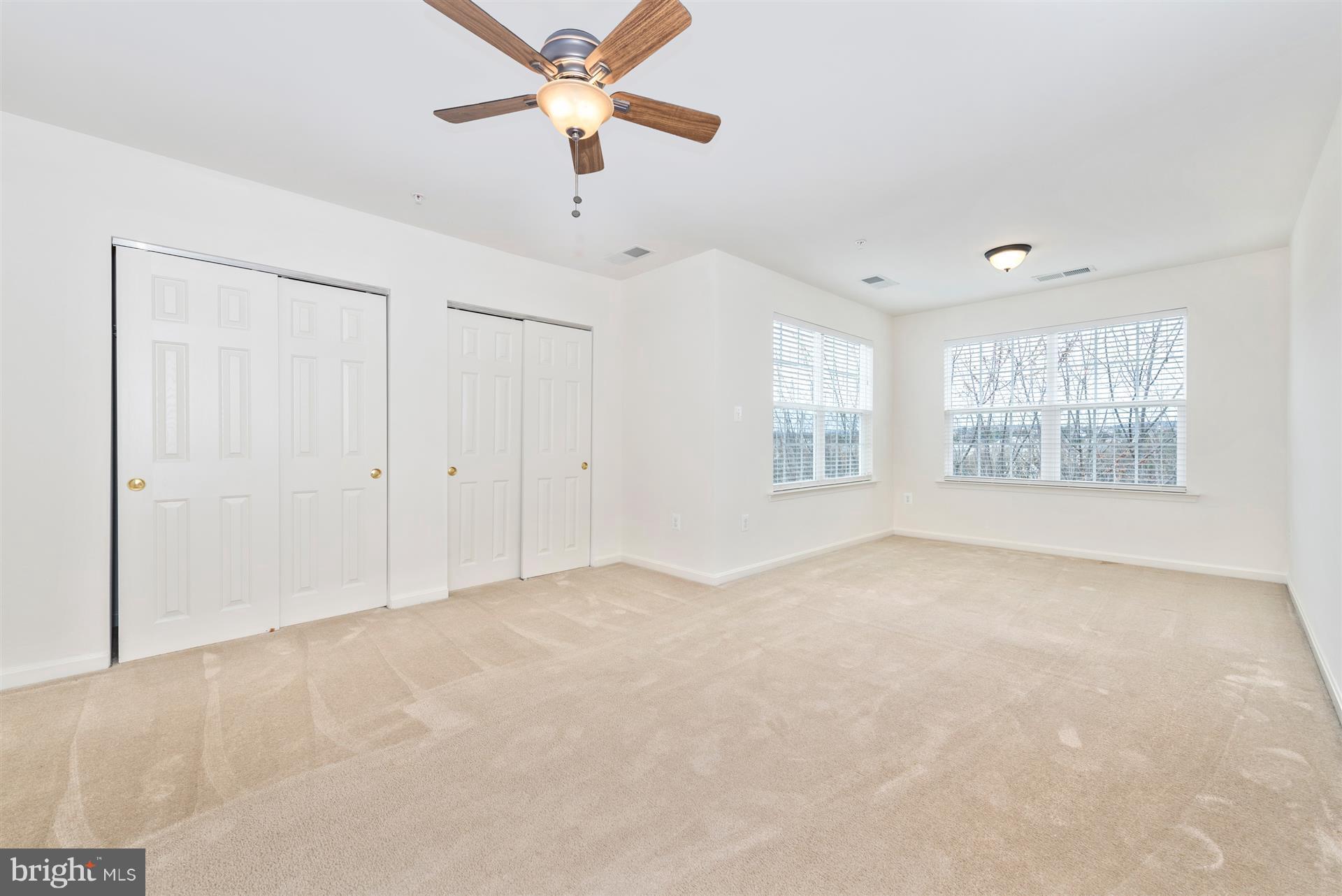 645 Tivoli Road Frederick, MD 21703 - Photo 2 of 21 an empty room with chandelier fan and windows