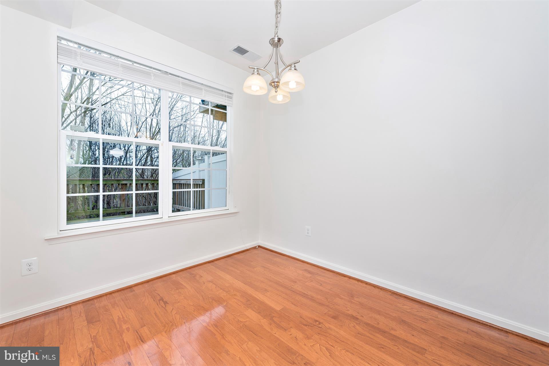 645 Tivoli Road Frederick, MD 21703 - Photo 13 of 21 a view of empty room with wooden floor and fan