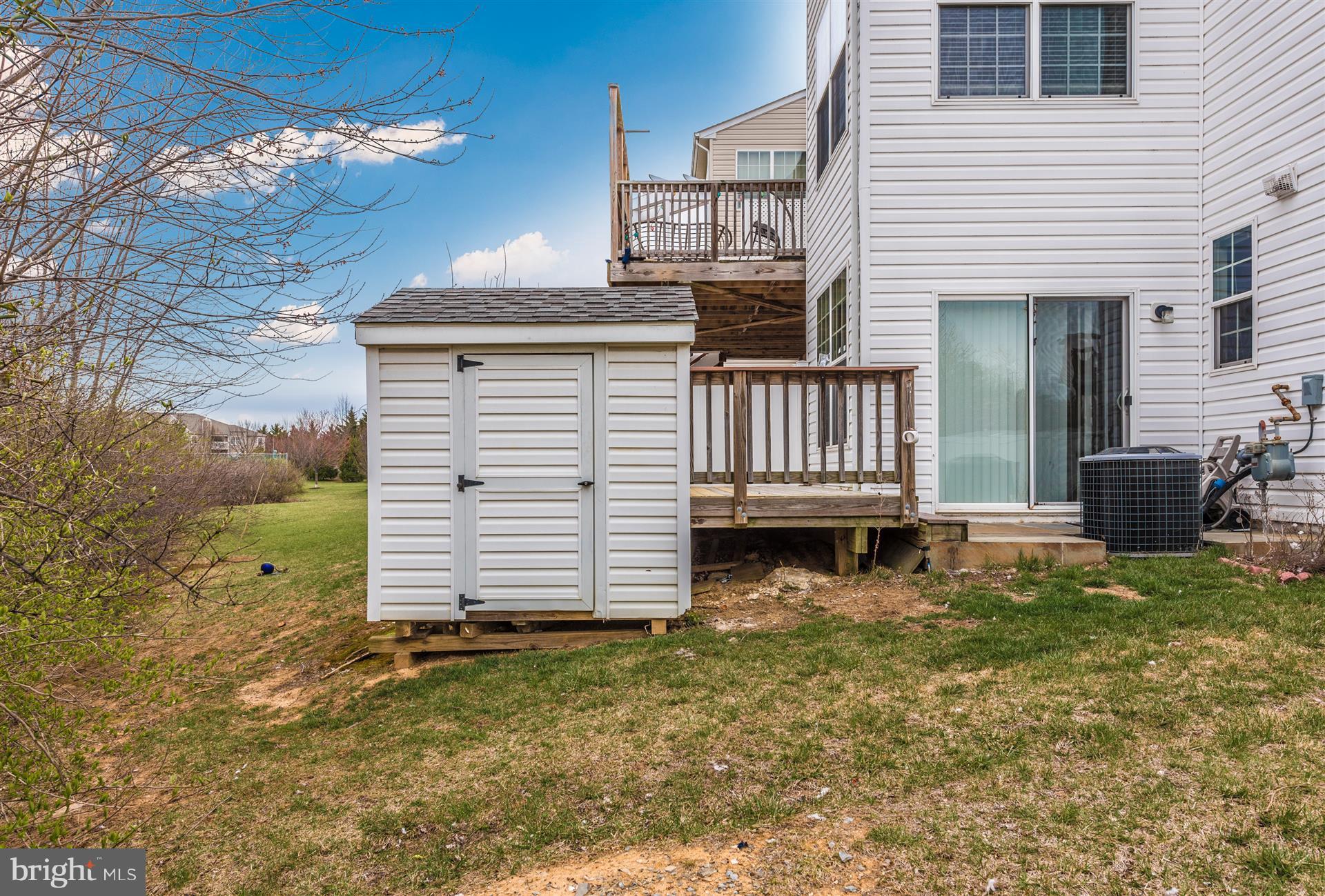 645 Tivoli Road Frederick, MD 21703 - Photo 19 of 21 a view of a house with backyard and sitting area