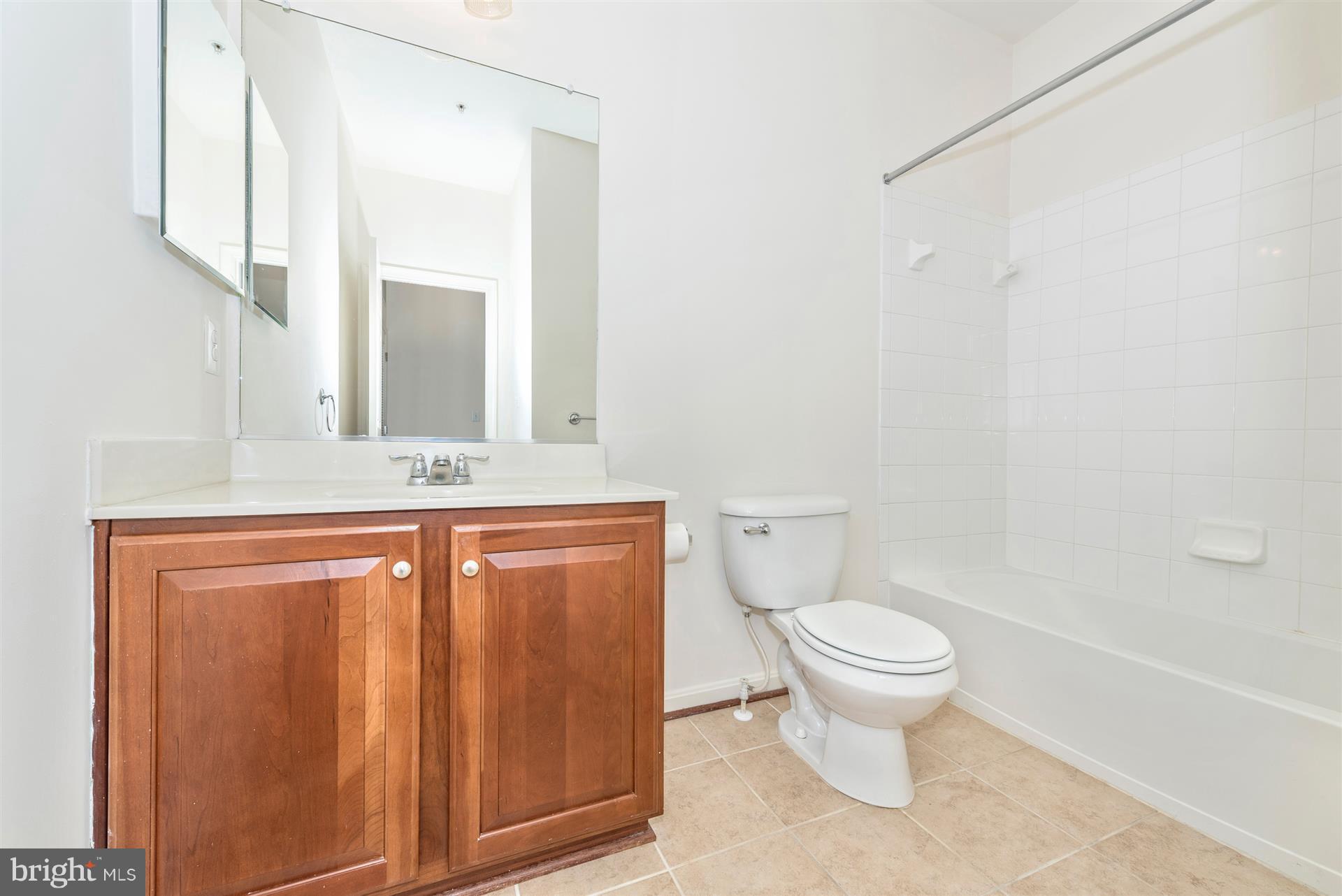 645 Tivoli Road Frederick, MD 21703 - Photo 3 of 21 a bathroom with a toilet sink and mirror