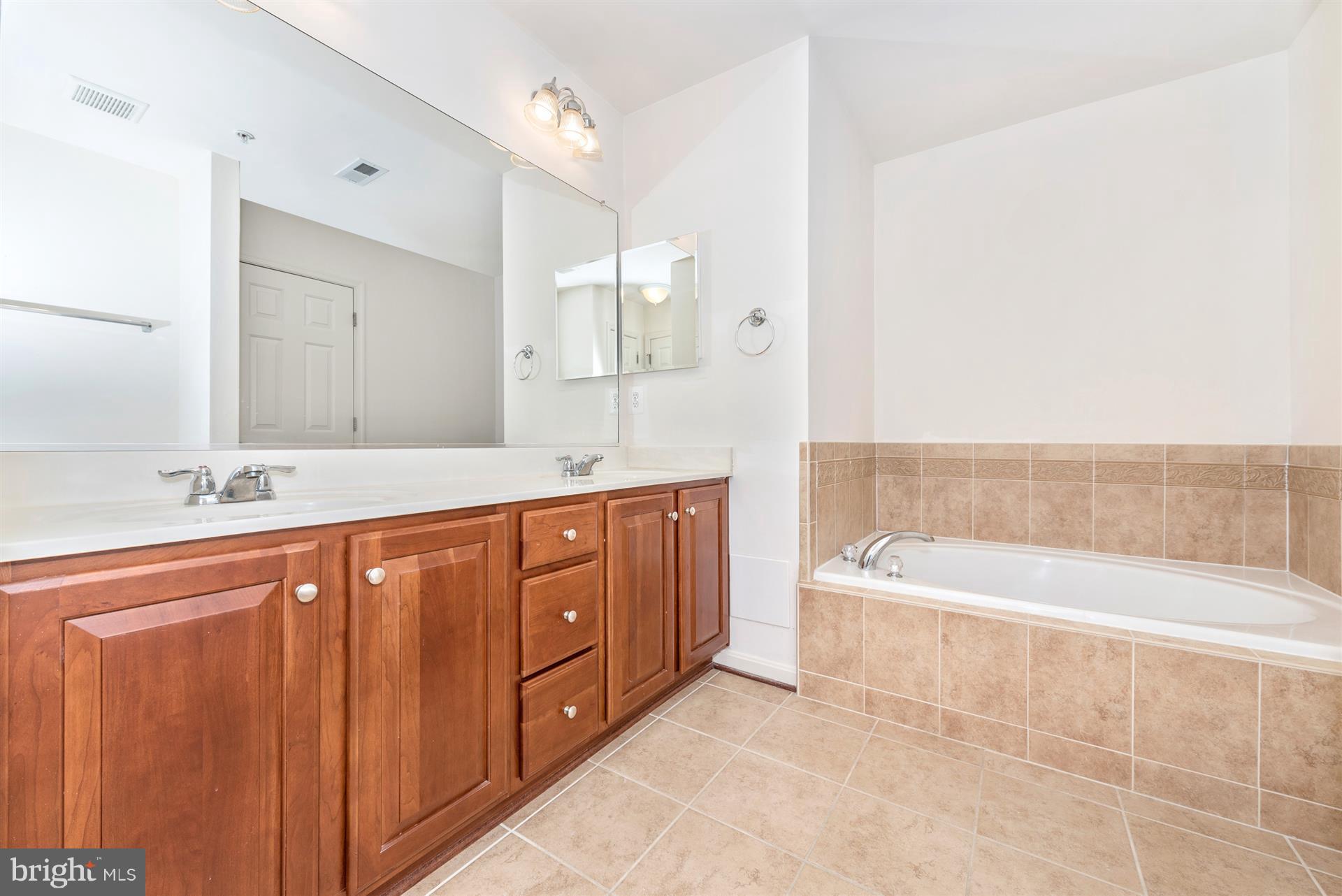 645 Tivoli Road Frederick, MD 21703 - Photo 6 of 21 a spacious bathroom with a tub sink and mirror