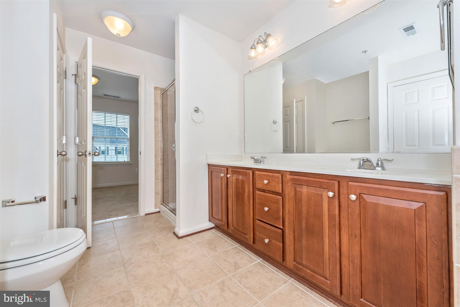 645 Tivoli Road Frederick, MD 21703 - Photo 7 of 21 a bathroom with a sink toilet and shower