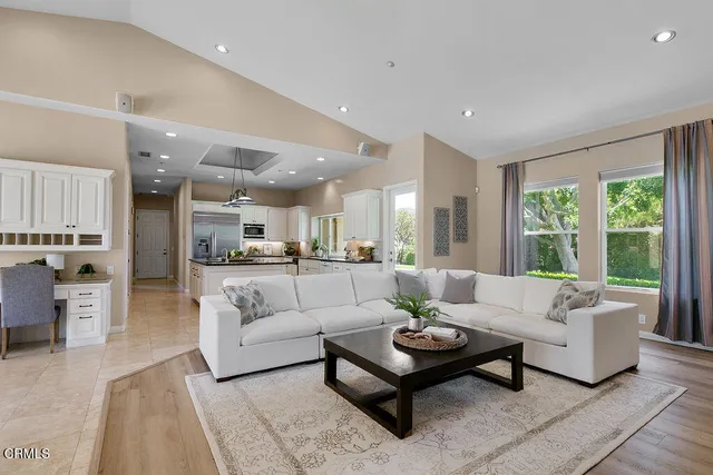 a bedroom with a bed and painting on the wall