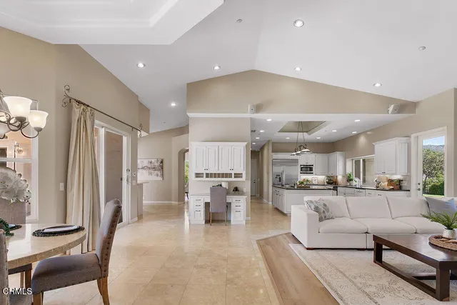 a spacious bedroom with a bed and a painting on the wall