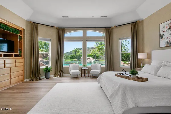 a bedroom with a bed and a painting on the wall