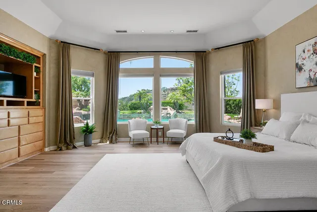 a bedroom with a bed and a painting on the wall