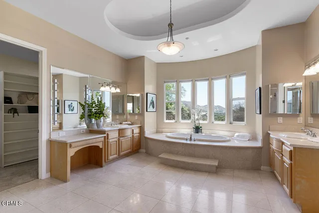 a front view of a house with a garden and trees