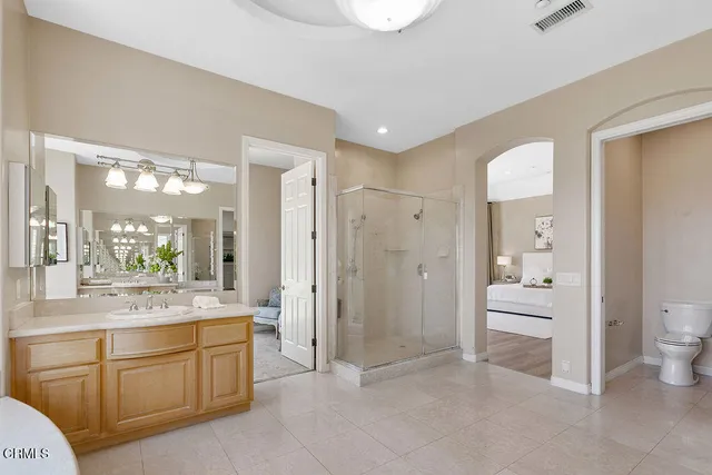 a front view of a house with a yard and potted plants