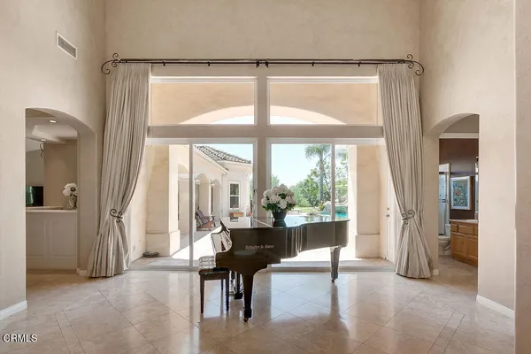a bedroom with a bed and a couch next to a window