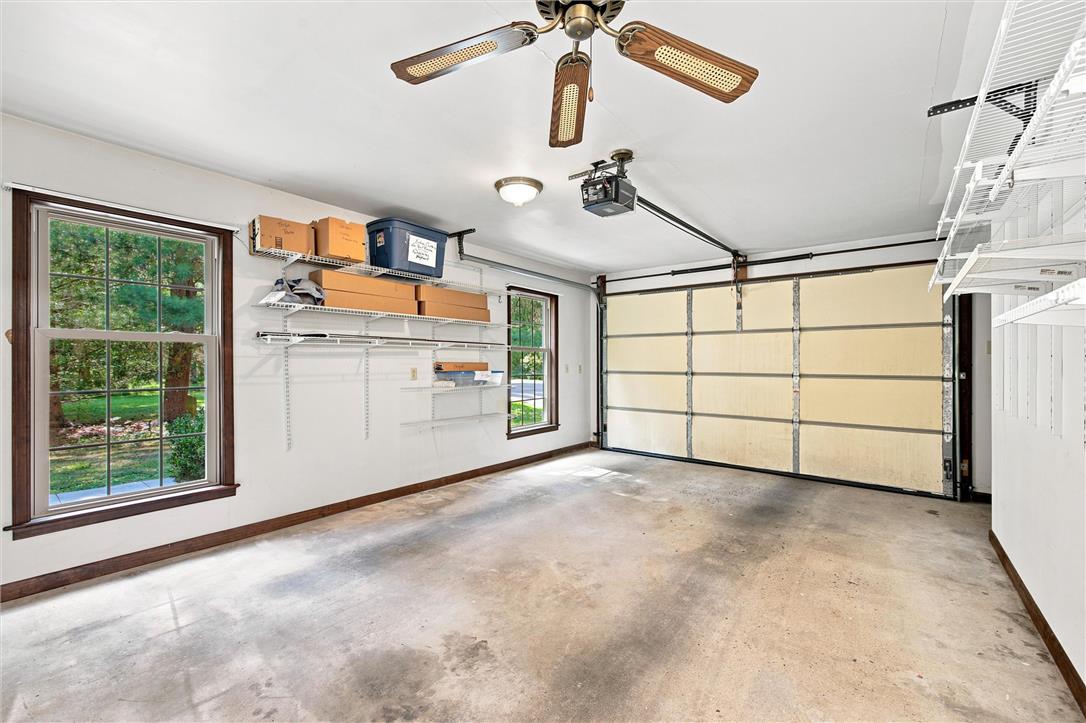 475 Crowthers Road Quakertown, PA 18951 - Photo 59 of 93 A spacious, clean garage featuring an automatic door, windows, and shelving for ample storage.