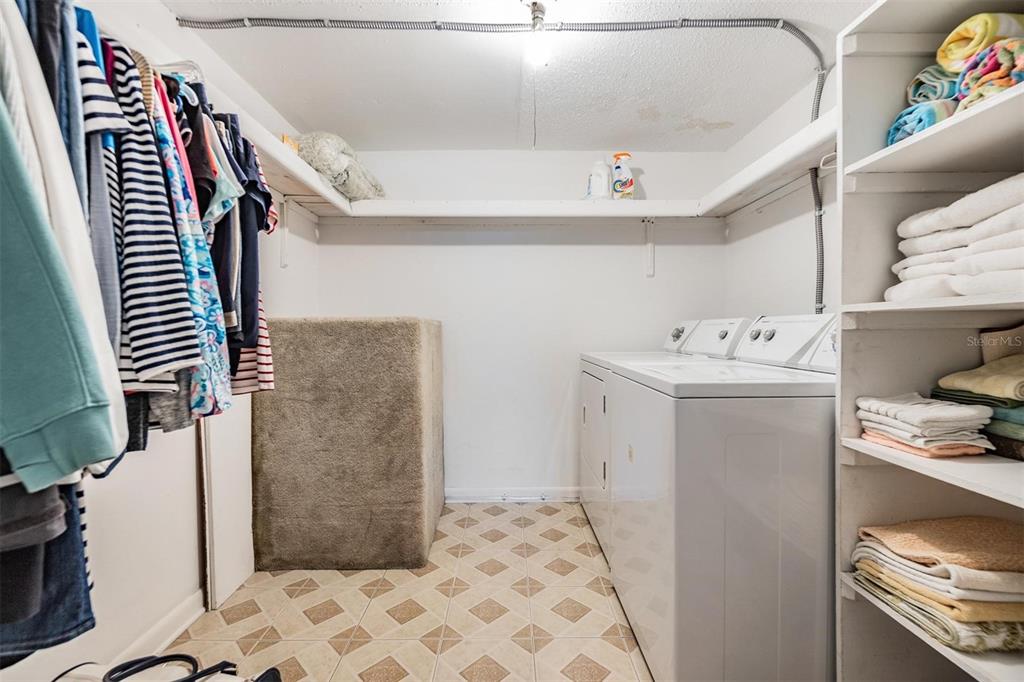 12760 Indian Rocks Road, Unit 104 Largo, FL 33774 - Photo 17 of 37 a utility room with cabinets washer and dryer