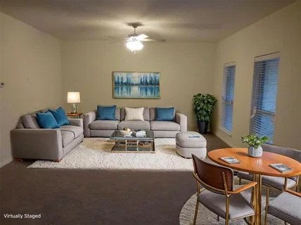 a living room with furniture and a potted plant