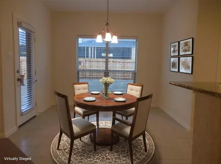 a view of a dining room with furniture and window