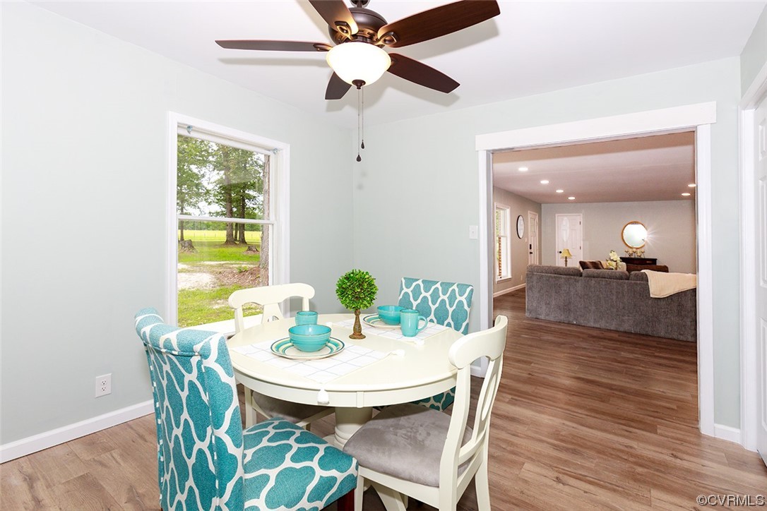 674 Spring Grove Road Spring Grove, VA 23881 - Photo 13 of 37 a view of a dining room with furniture and a potted plant