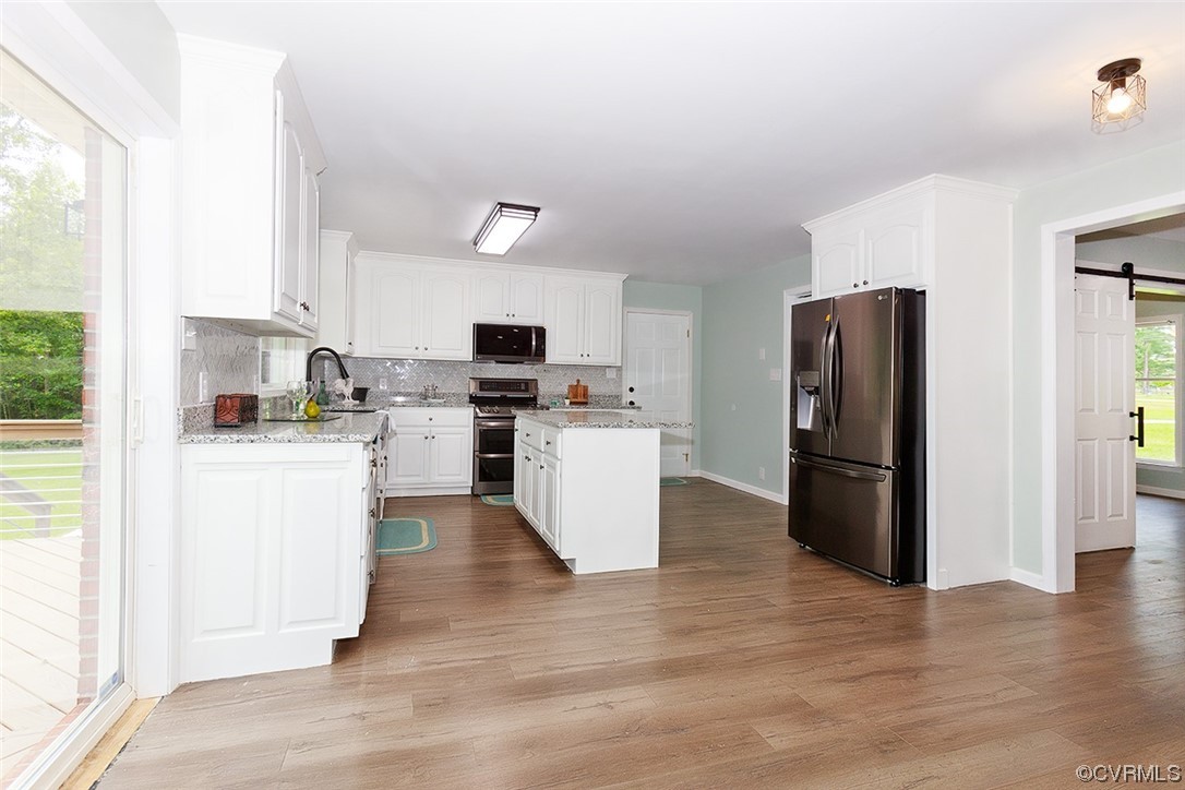 674 Spring Grove Road Spring Grove, VA 23881 - Photo 18 of 37 a kitchen with a refrigerator a stove top oven and a window