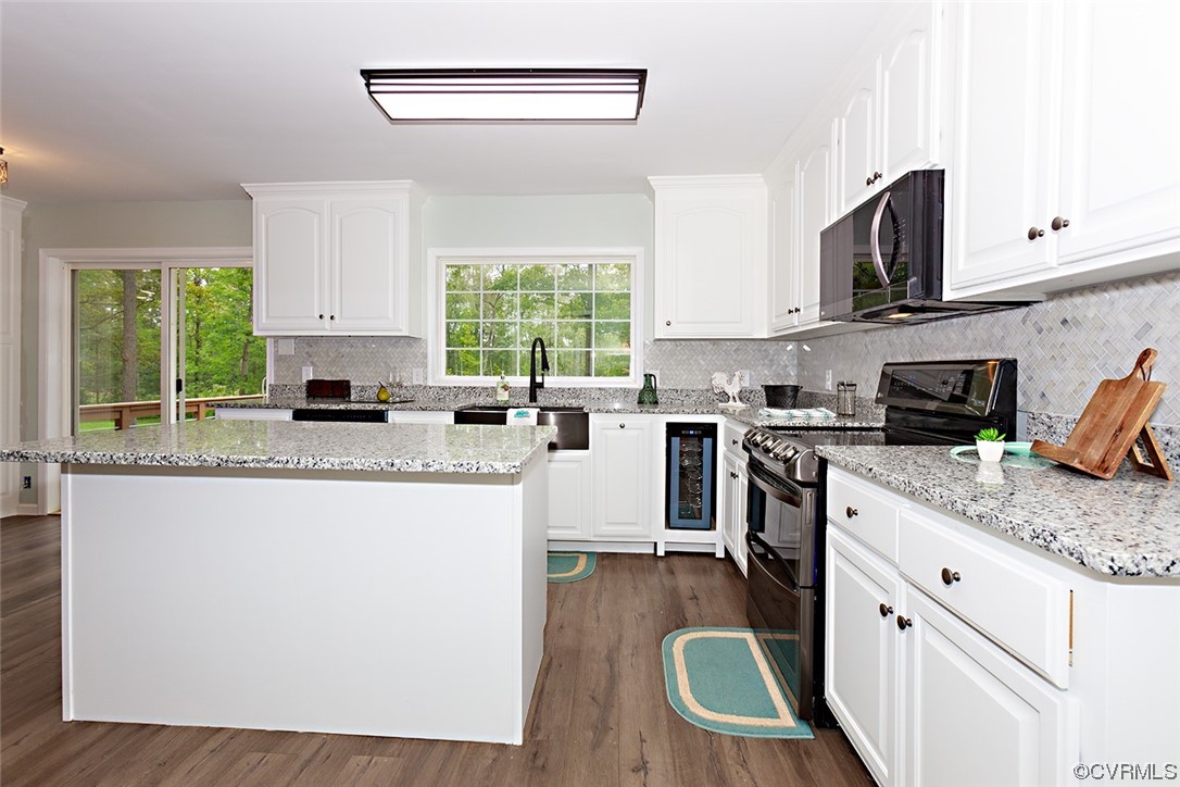 674 Spring Grove Road Spring Grove, VA 23881 - Photo 20 of 37 a kitchen with stainless steel appliances granite countertop a stove a sink and a microwave