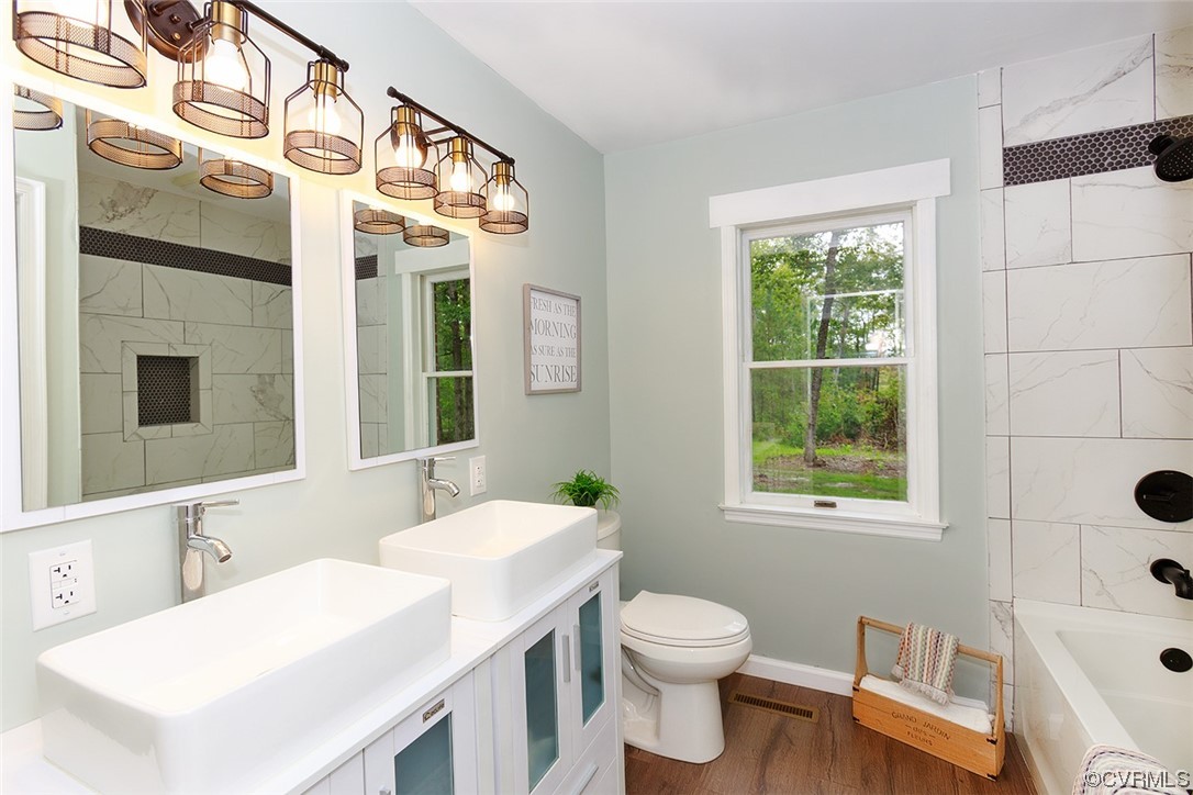 674 Spring Grove Road Spring Grove, VA 23881 - Photo 21 of 37 a bathroom with a sink a toilet and a mirror