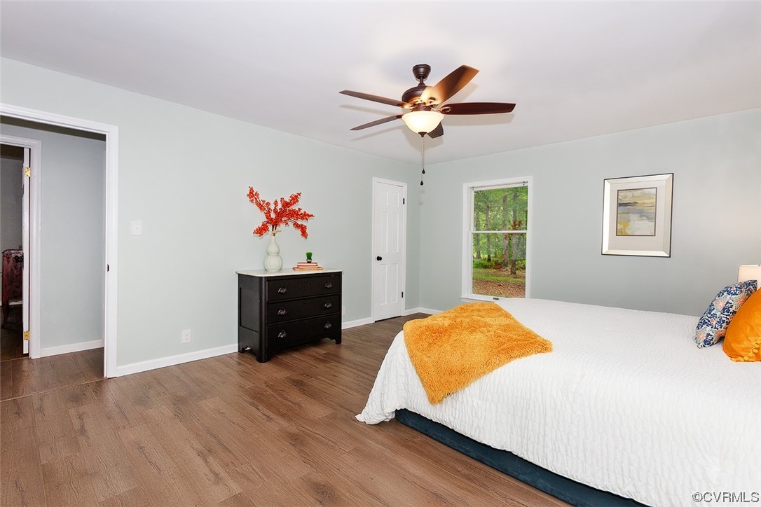 674 Spring Grove Road Spring Grove, VA 23881 - Photo 27 of 37 a bed room with a bed and a chandelier