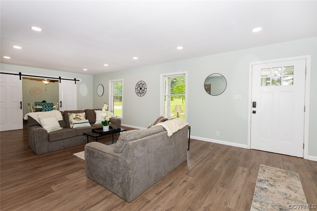 674 Spring Grove Road Spring Grove, VA 23881 - Photo 7 of 37 a living room with couches and kitchen view with wooden floor