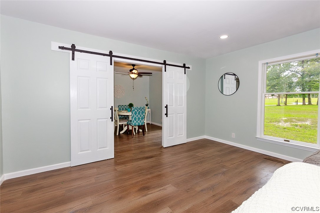 674 Spring Grove Road Spring Grove, VA 23881 - Photo 10 of 37 a view of an empty room with window and wooden floor